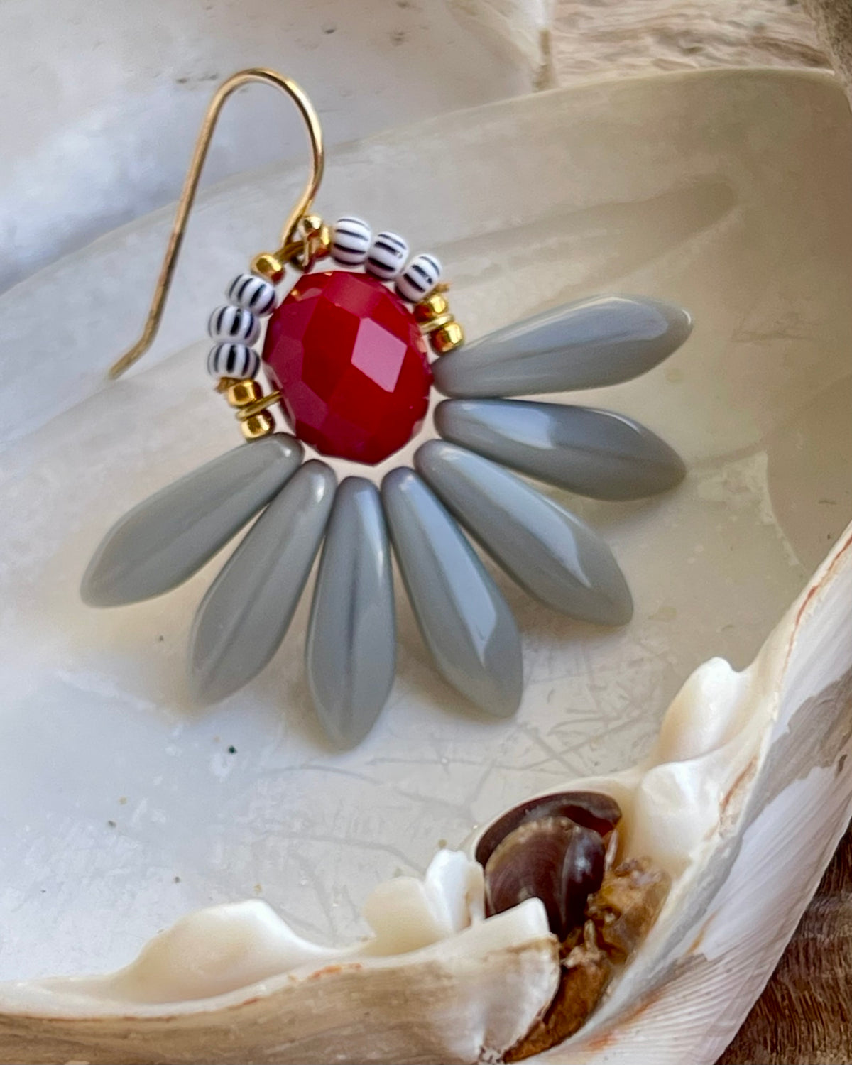 Stor blomsterørering med mørkerød glasperle i midten og flotte grå glasperler som blade.